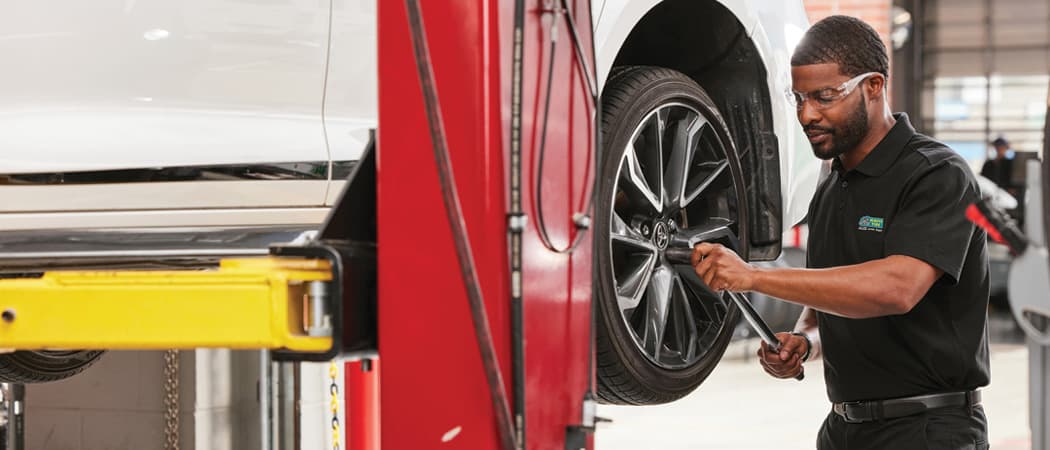 Mavis tech removing tire for tire rotation