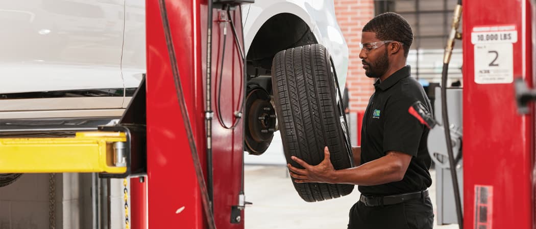 mavis tech removing a tire for a balancing and alignment check
